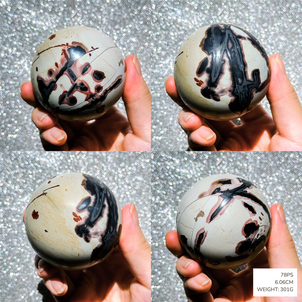 Four views of a marbled sphere held by a hand against a glittery background