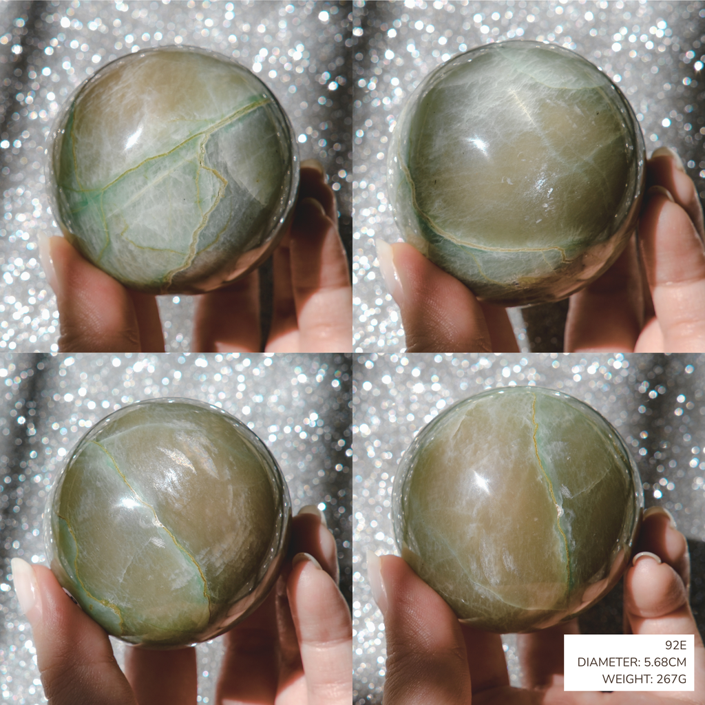 Four-panel collage showing a hand holding a polished oval stone sphere against a sparkly silver background. The stone has a muted olive-green to gray color with natural veining.